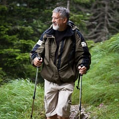 active mature man nordic walking outdoors